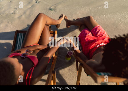 Couple relaxing with hand in hand on the beach Stock Photo