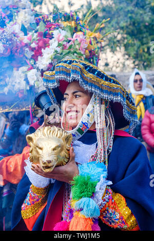 Choquekillka Festival procession. Woman carrying Señor de Choquekillka image, Peruvian Sacred Valley of the Incas city of Ollantaytambo, Peru. Stock Photo