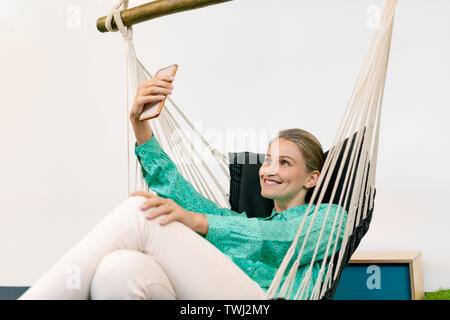 Businesswoman taking selfie with mobile phone Stock Photo