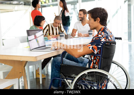 Disabled businessman using laptop in the conference room Stock Photo
