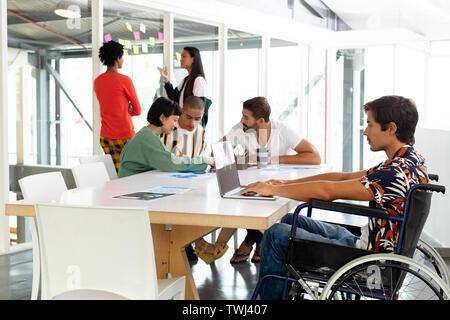 Disabled businessman using laptop in the conference room Stock Photo