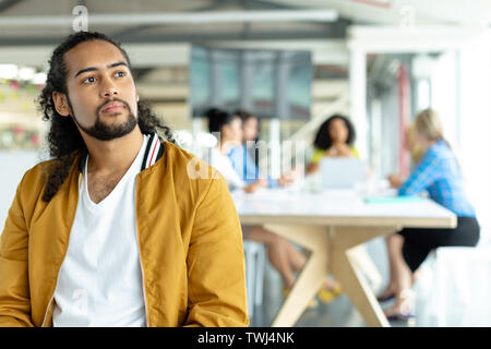 Businessman looking away at conference room in a modern office Stock Photo