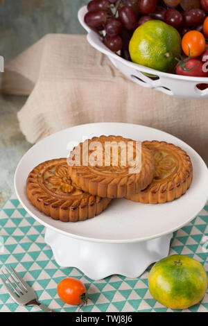 Moon cakes and fruit on the table Stock Photo