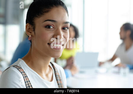 Happy businesswoman looking at camera in a modern office Stock Photo