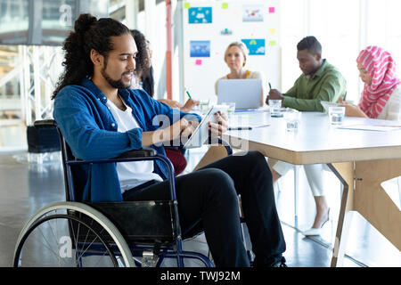 Disabled businessman using digital tablet in conference room during meeting Stock Photo
