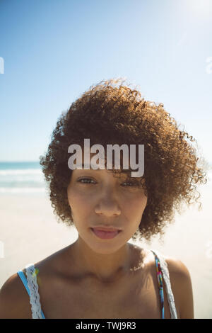 Beautiful woman standing on the beach Stock Photo