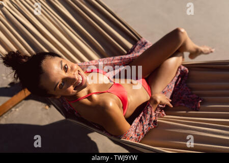 Summer relaxation. Full length top view of attractive young woman in  swimwear keeping hands behind head while lying down in hammock outdoors  13450494 Stock Photo at Vecteezy