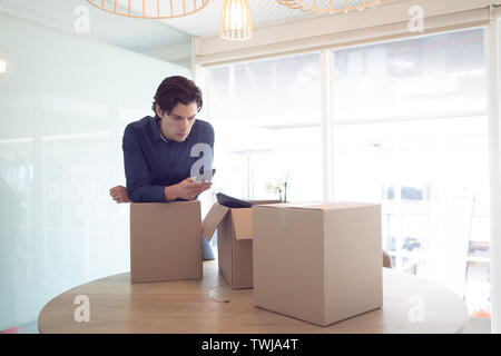 Male executive using mobile phone in office Stock Photo