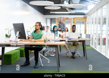 Business people working at desk in a modern office Stock Photo