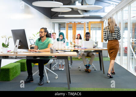 Business people working at desk in a modern office Stock Photo
