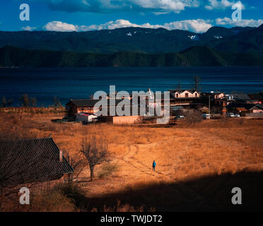 A man walked to the small village next to Lugu Lake. Stock Photo