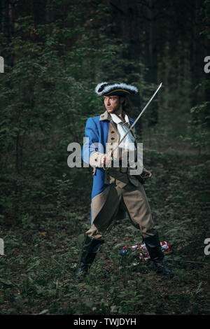 Man dressed as soldier of War of Independence USA attacks with saber in battle. 4 july independence day of USA concept photo composition: soldier, pis Stock Photo