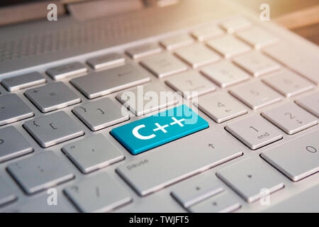 Keyboard close-up, without many keys. button with inscription C and Enter, push button. blue button on grey silver laptop keyboard. copy space to test Stock Photo