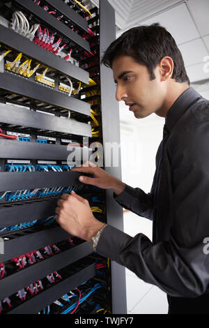 Technician working in a server room Stock Photo