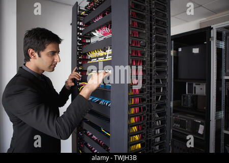 Technician working in a server room Stock Photo
