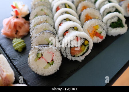 close up assorted sushi rolls, setup nicely on a table Stock Photo