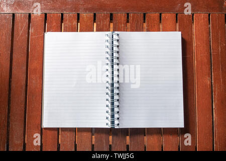 Open empty white notebook with line on wooden table Stock Photo