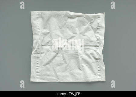Empty unused crumpled white tissue on gray background Stock Photo
