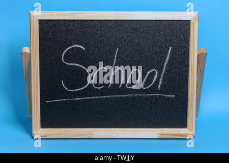 Handwritten inscription in chalk school on a green blackboard. Stock Photo