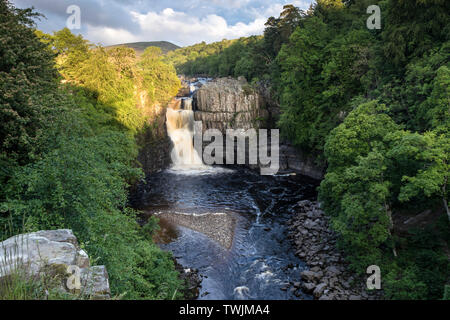 Teesdale, County Durham, UK.  21st June 2019. UK Weather.  The rising sun illuminates the River Tees at High Force on the morning of the summer solstice. Credit: David Forster/Alamy Live News Stock Photo