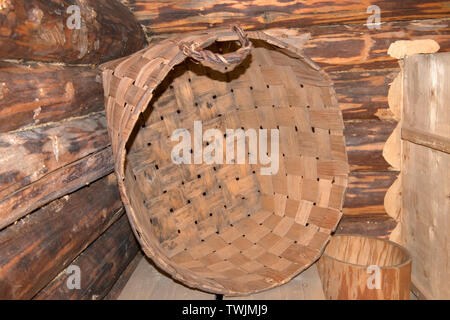 Wicker basket in the interior of an old peasant hut Stock Photo