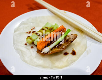 Peking duck roasted with carrot onion cucumber on tortilla sheet Stock Photo