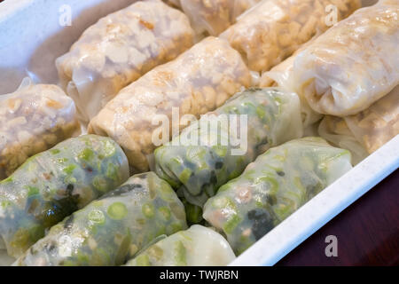 Noodle rice wrap with stuffed tofu and bean sliced fried in plastic box,thai food Stock Photo