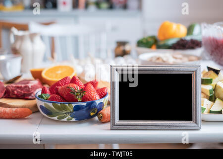 Blank picture frame with fruit, vegetable and meat for lunch on table Stock Photo