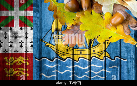 Saint Pierre and Miquelon flag on autumn wooden background with leaves and good place for your text. Stock Photo