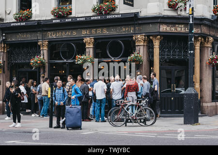 London, UK - June 15, 2019: People standing and drinking outside The Ten Bells pub in Shoreditch, East London. The pub is famous for its supposed asso Stock Photo