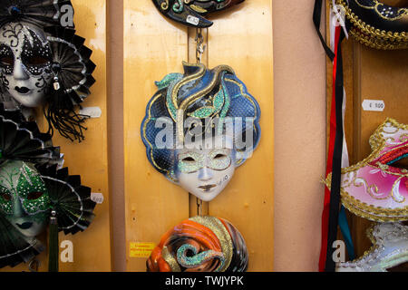 Venetian masks and souvenirs on sale to tourists in a gift shop in Sirmione, Lake Garda, northern Italy. Stock Photo