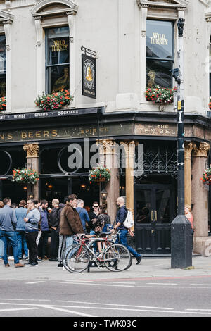 London, UK - June 15, 2019: People standing and drinking outside The Ten Bells pub in Shoreditch, East London. The pub is famous for its supposed asso Stock Photo