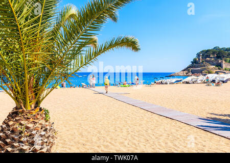 TOSSA DE MAR, SPAIN - JUN 3, 2019: People dining in restaurant on sandy ...