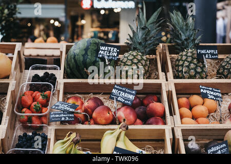 London, UK - June 15, 2019: Fresh fruits in wooden crates on sale at Spitalfields Market, one of the finest surviving Victorian Market Halls in London Stock Photo