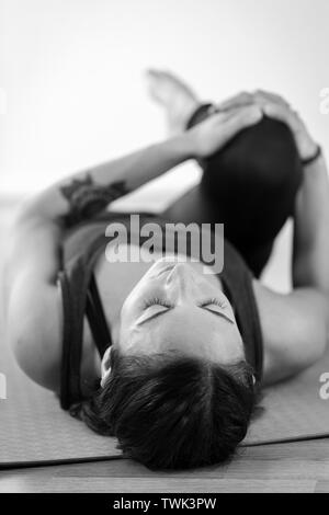 Young Female In Wind Relieving Pose Stock Photo - Download Image Now - Yoga,  Activity, Adult - iStock