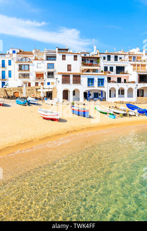 Traditional fishing boats on beach in Calella de Palafrugell, scenic village with white houses and sandy beach with clear blue water, Costa Brava, Cat Stock Photo