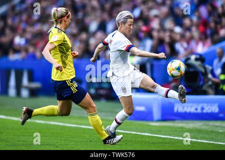 Megan Rapinoe, right, of United States women's national soccer team passes the ball against Amanda Ilestedt of Sweden women's national football team in the third round match of Group F match during the FIFA Women's World Cup France 2019 in Paris, France, 20 June 2019. The United States came out the last but record-setting group leaders to make the FIFA Women's World Cup knockouts after beating Sweden 2-0 in Le Havre, France on Thursday. Stock Photo