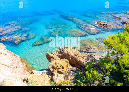 Rocks in azure sea water near Sa Riera village, Costa Brava, Spain Stock Photo