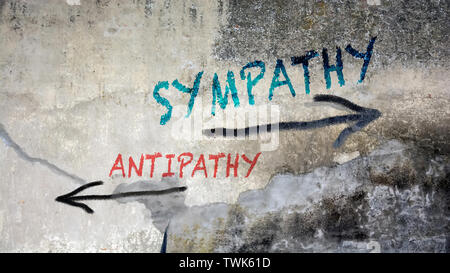 Wall Graffiti the Direction Way to Sympathy versus Antipathy Stock Photo