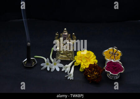 Ganesha with flowers and incense stick. Stock Photo