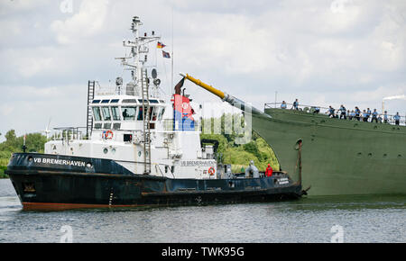 Bremerhaven, Germany. 21st June, 2019. The naval training ship 'Gorch Fock' is undocked from a dock of the Bredo shipyard by a tug (l). The naval training ship 'Gorch Fock' is being launched in Bremerhaven today after more than three years in the dock. Credit: Axel Heimken/dpa/Alamy Live News Stock Photo