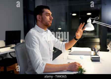 businessman using gestures at night office Stock Photo