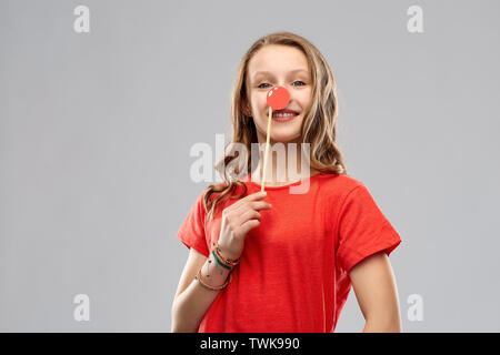 smiling teenage girl with red clown nose Stock Photo