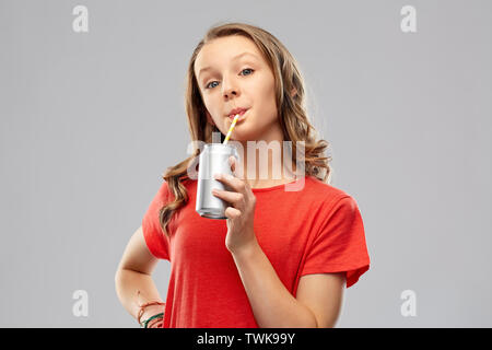 girl drinking soda from can through paper straw Stock Photo