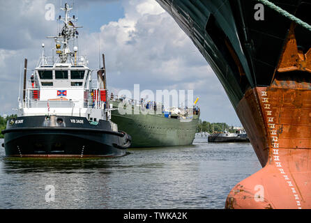 Bremerhaven, Germany. 21st June, 2019. The naval training ship 'Gorch Fock' (M right) is undocked from a dock of the Bredo shipyard by a tug. The naval training ship 'Gorch Fock' is being launched in Bremerhaven today after more than three years in the dock. Credit: Axel Heimken/dpa/Alamy Live News Stock Photo