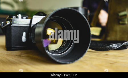 Old, vintage, retro style Spotmatic Pentax camera on wooden table Stock Photo