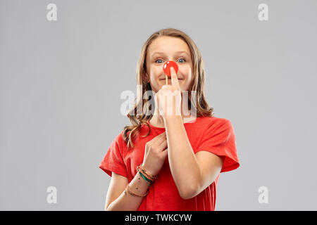 smiling teenage girl with red clown nose Stock Photo