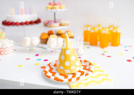 party caps, food and drinks on birthday Stock Photo