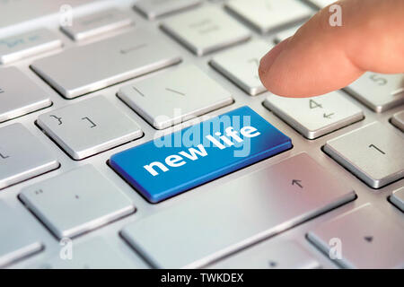 New life the inscription on the blue button on the laptop keyboard. the concept of change in life. change of job, termination of employment. Stock Photo