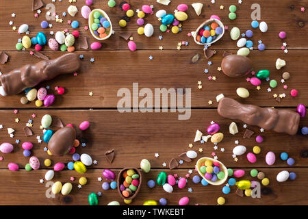chocolate eggs, easter bunnies and candies on wood Stock Photo